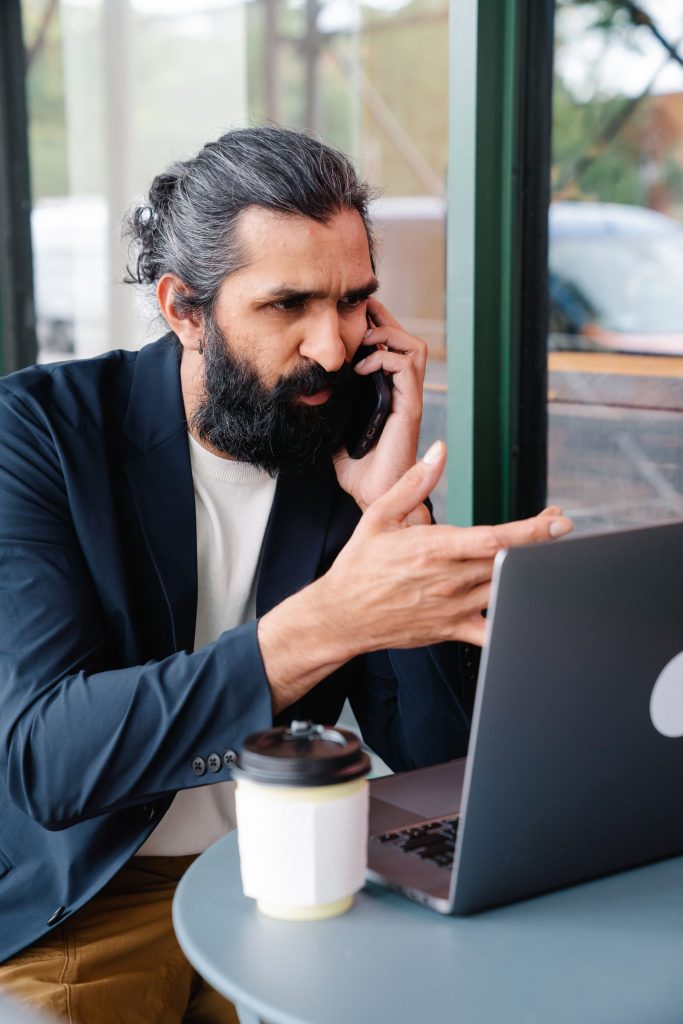 Indian business owner calling a customer about overdue payments