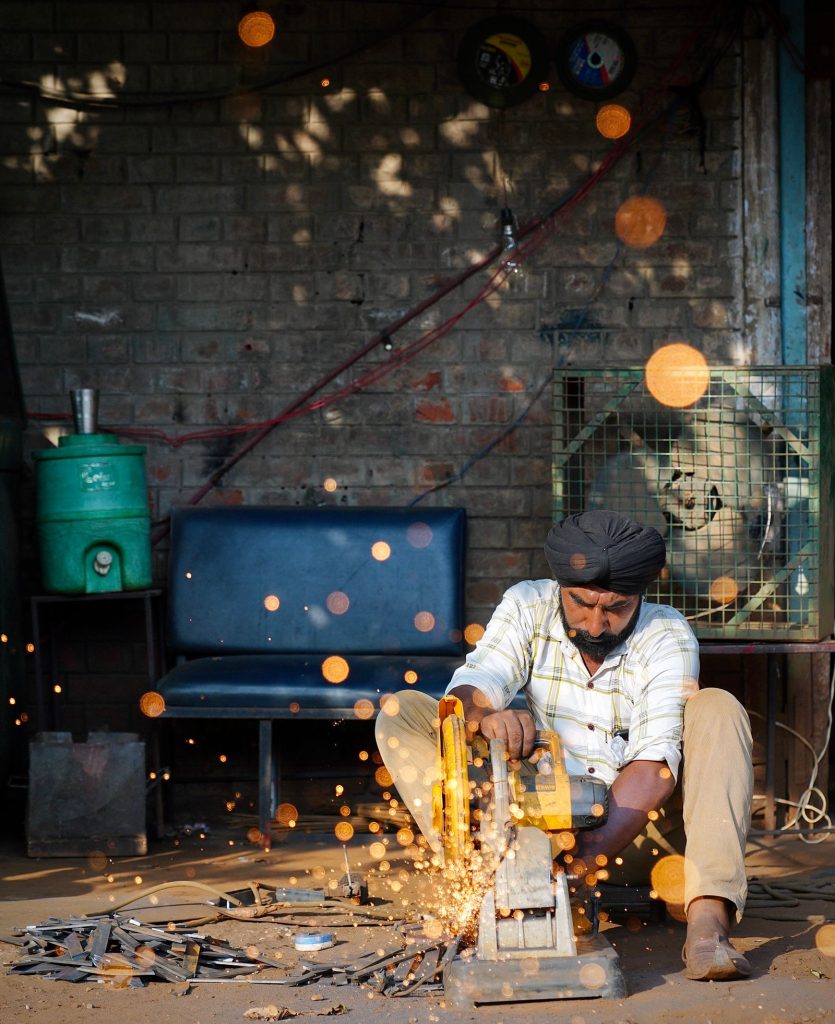 Owner working at his Indian manufacturing workshop