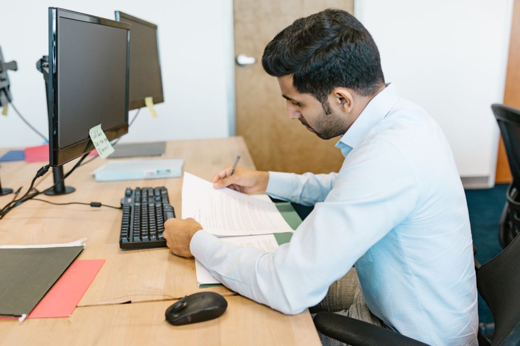 Indian business owner checking GST documents at his desk
