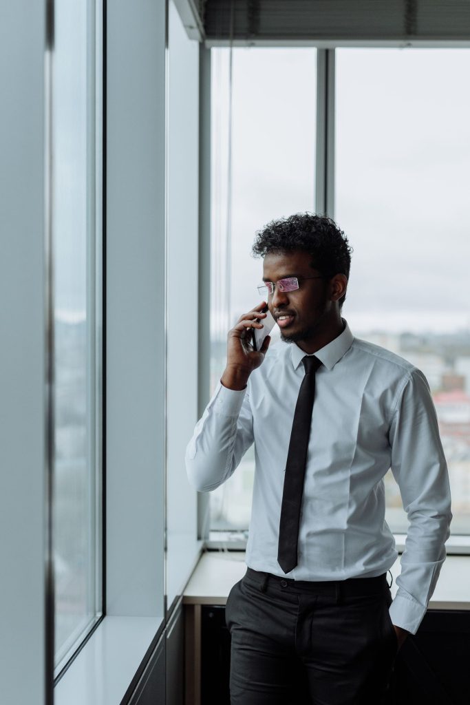 Indian businessman speaking on the phone about a payment