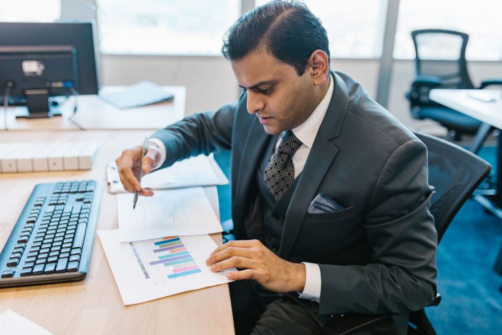 Indian business owner reviewing a buyer’s credit report