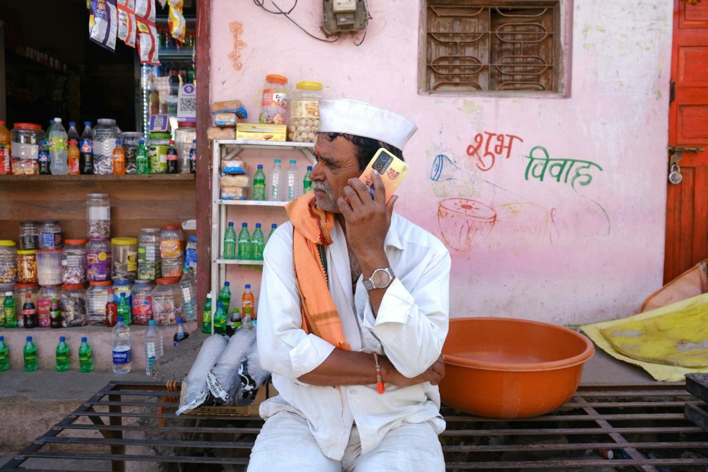 Indian shopkeeper answering a payment reminder call