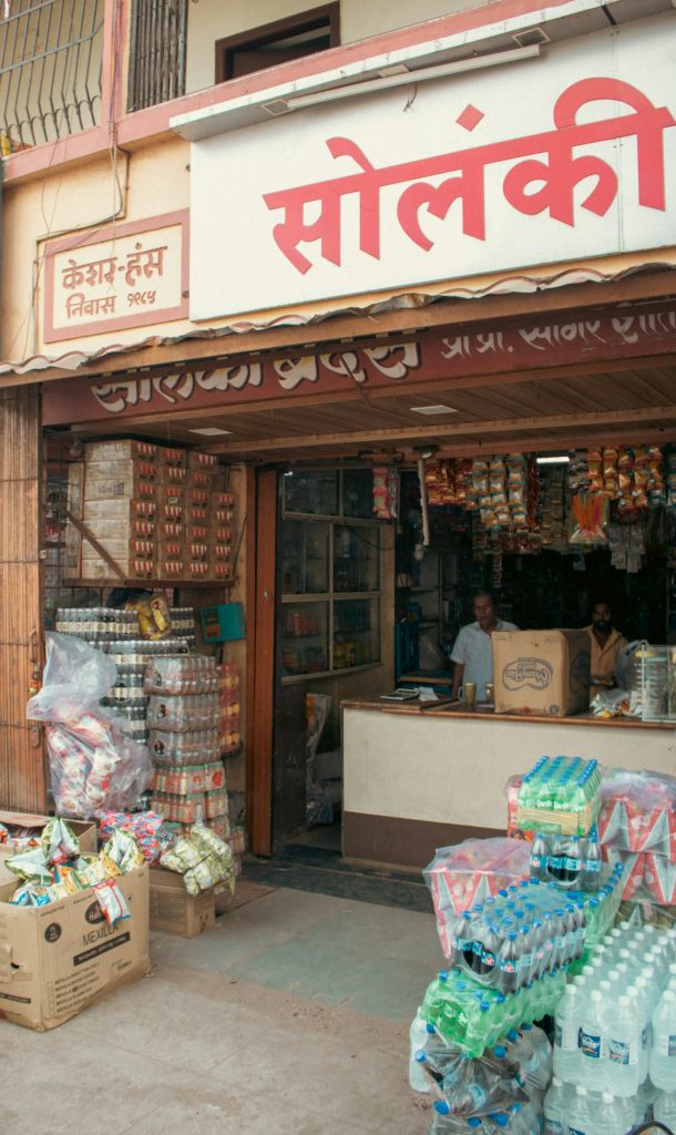 Indian shop owner at the counter of his retail store