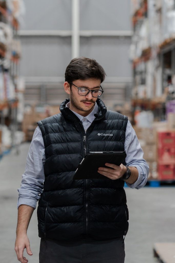 Indian distributor using a business app on a tablet in his warehouse